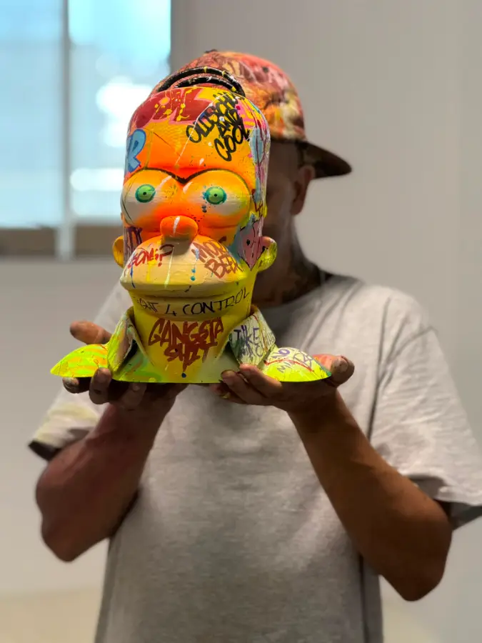 A person holding a brightly coloured custom 3D printed bust made by 3DOME Malta